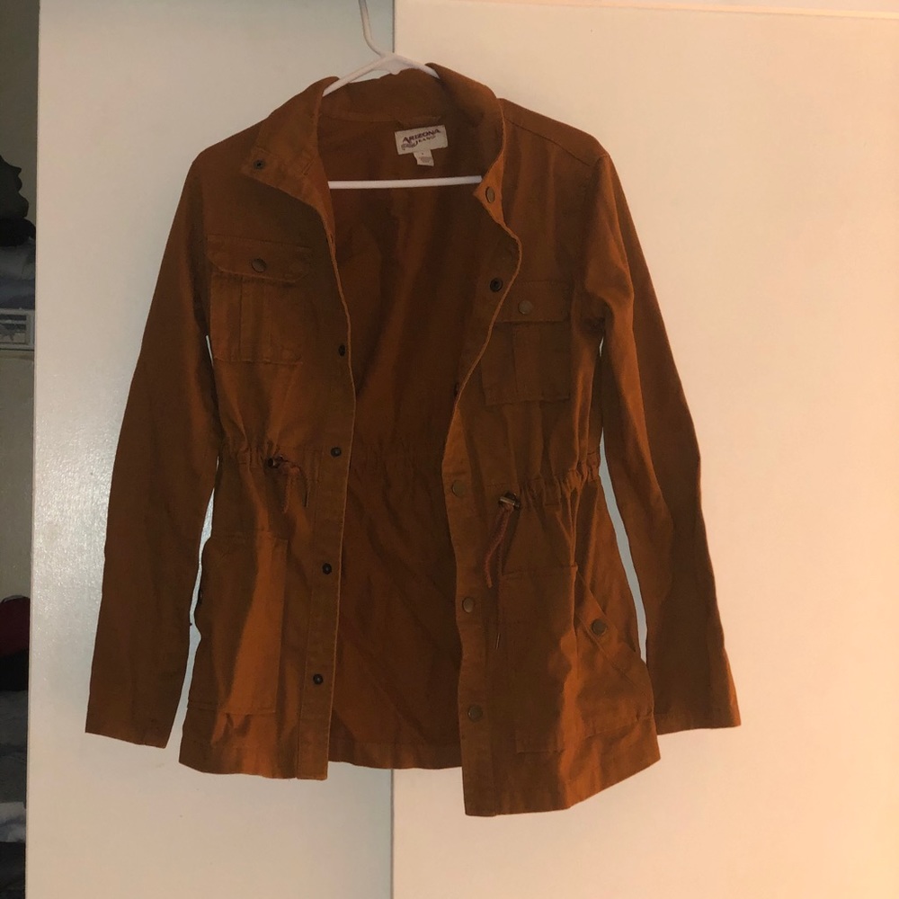Brownish jacket. Light coat.